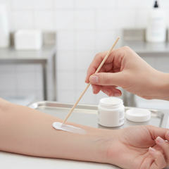 Hand applying ointment with applicator