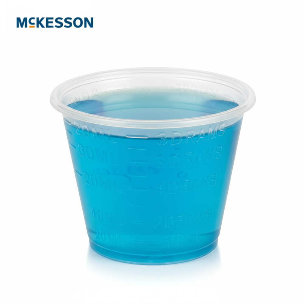 Medicine cup filled with colored liquid