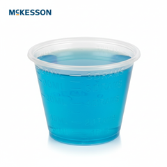 Medicine cup filled with colored liquid