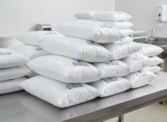 Multiple pillows stacked showing bulk quantity