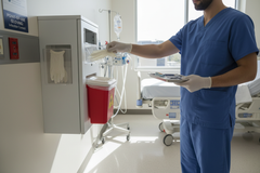 Healthcare Professional Using Glove Box Holder Point-of-Use Access